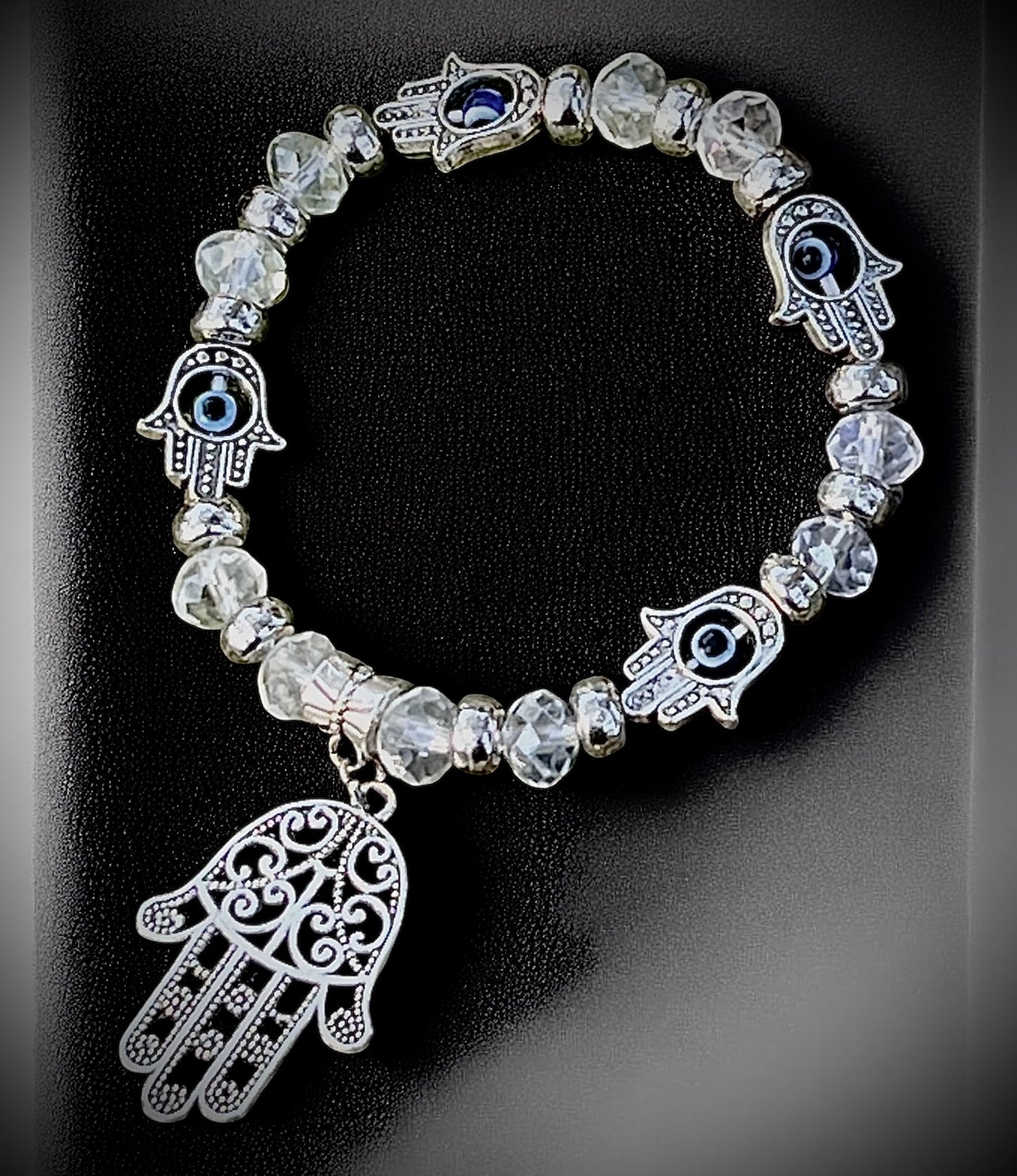 Clear beaded hamsa and evil eye bracelet for protection, clarity, and spiritual shielding.