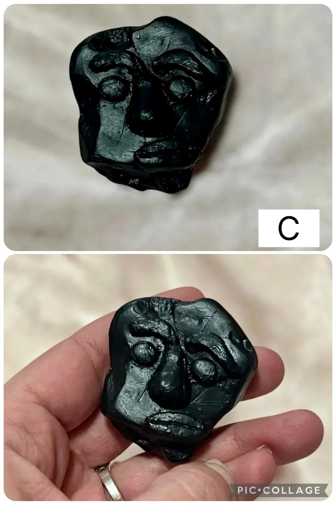 Black protection stone with handmade clay face