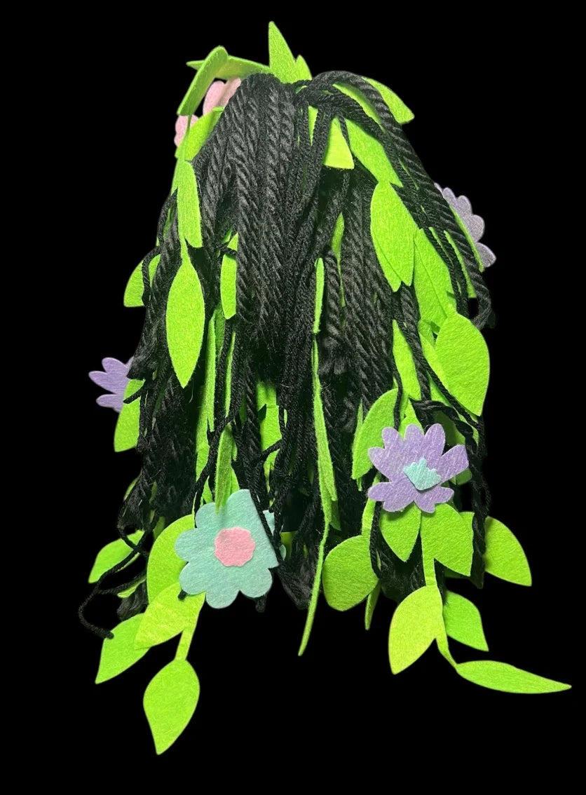 Artisan-crafted Poison Ivy spirit doll with natural elements and vibrant colors.