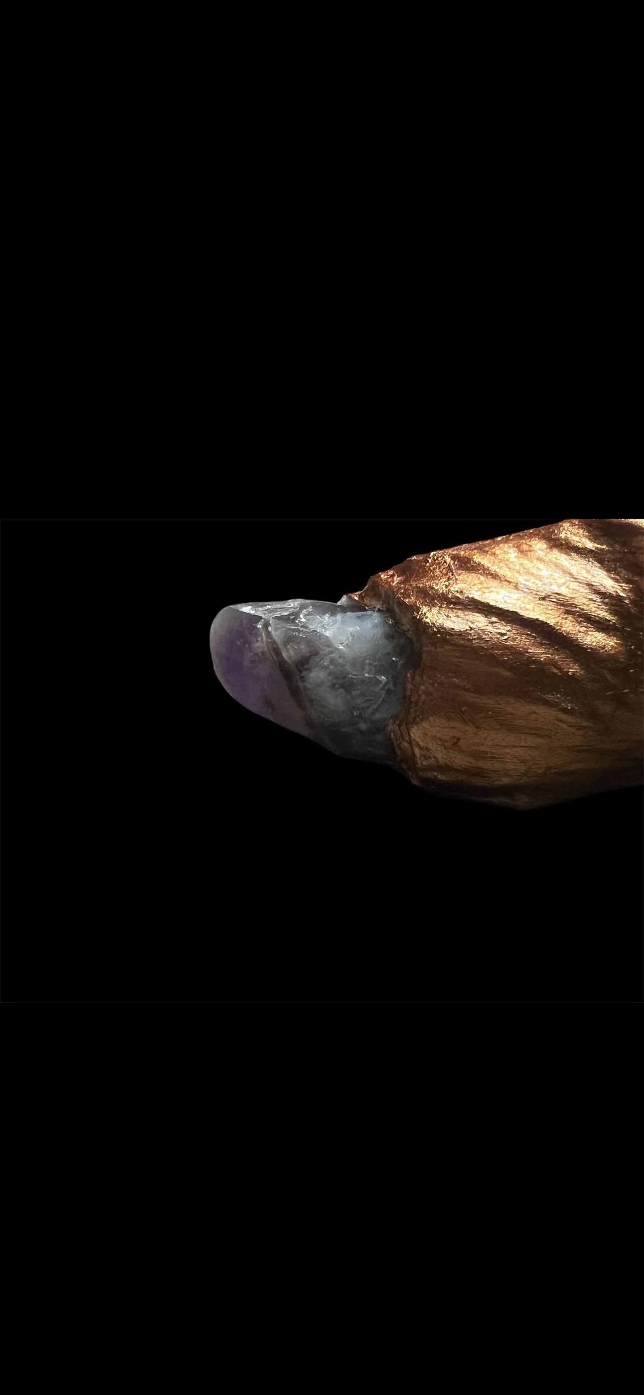 Jester wand with vibrant ribbons and amethyst crystal at the bottom, perfect for magical rituals.