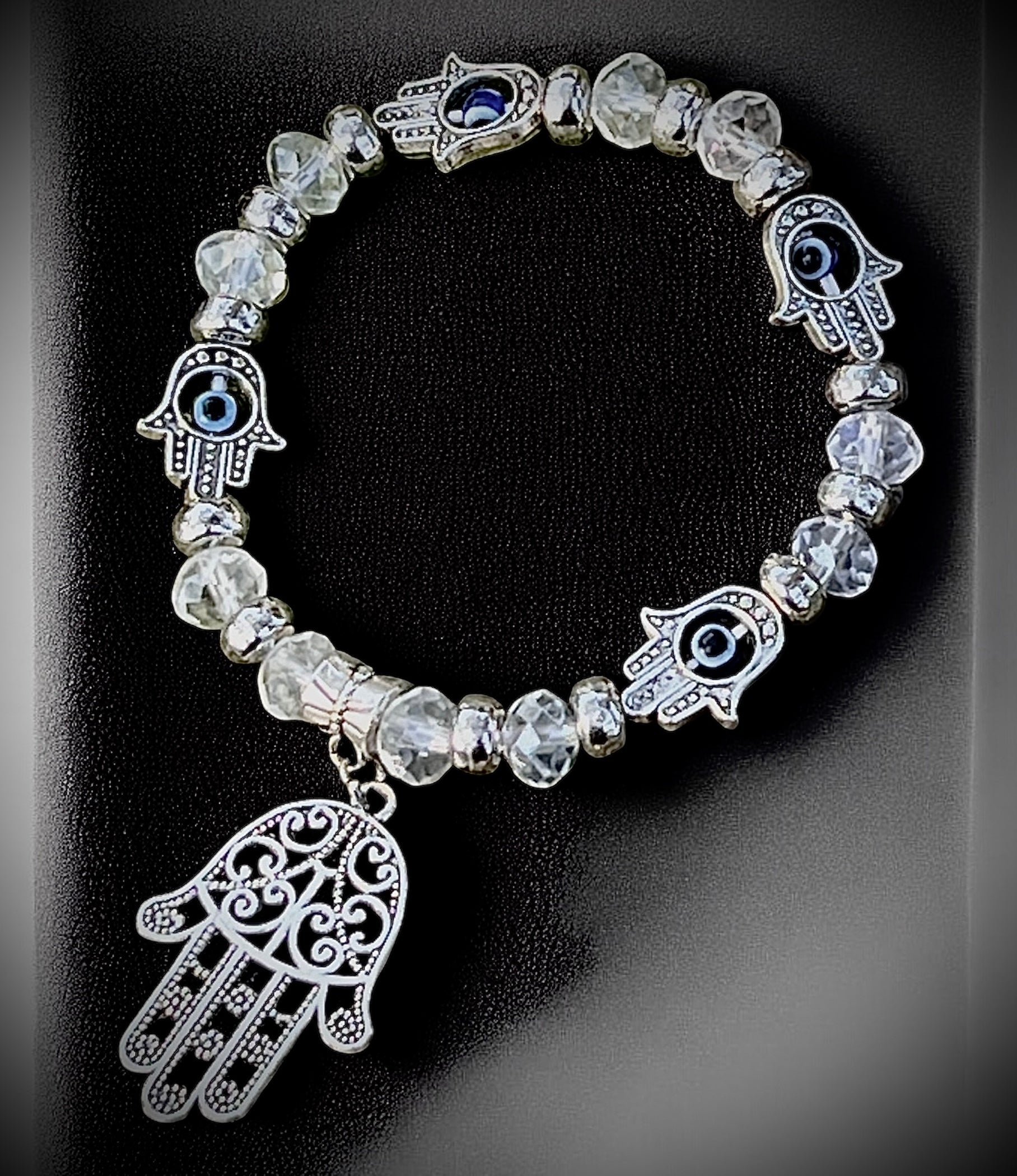 Clear beaded hamsa and evil eye bracelet for protection, clarity, and spiritual shielding.