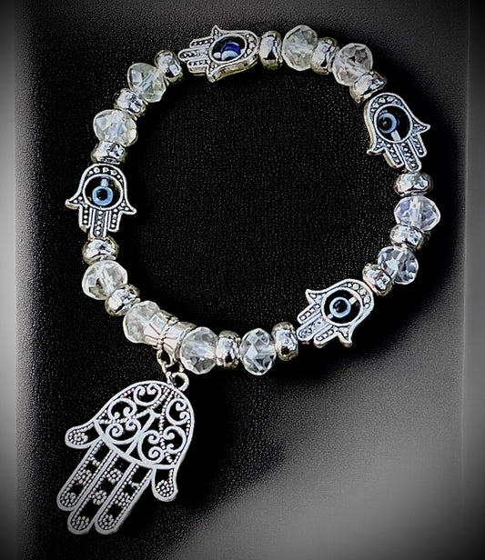 Clear beaded hamsa and evil eye bracelet for protection, clarity, and spiritual shielding.