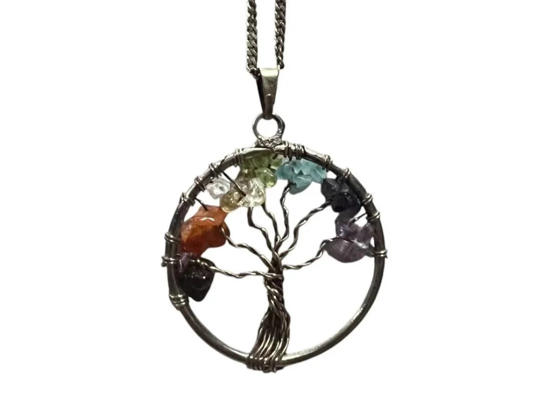Mystical Tree of Life chakra pendant surrounded by crystals, capturing boho energy and sacred harmony